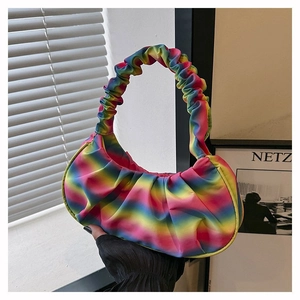 Detail of vibrant rainbow gradient pleated shoulder bag with soft cloud-like texture