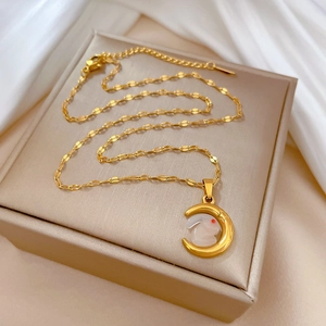 Detail of gold rabbit on crescent moon pendant displayed on a premium jewelry gift box