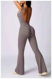 Detail of taupe yoga jumpsuit featuring an open back and flattering flared leg design