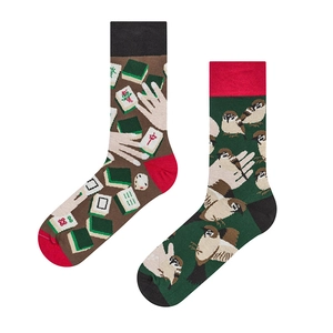 Detailed view of mismatched crew socks with mahjong patterns and sparrow jacquard design