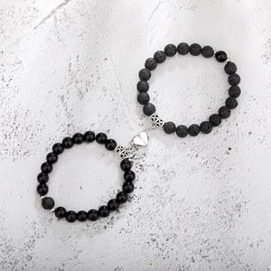 Detail of heart magnet clasp connecting two natural tiger eye and lava stone bracelets