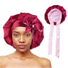 Dual-sided satin sleeping bonnet with ruffle trim and ribbon tie in wine red and pink
