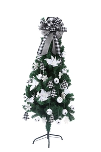 Detail of Christmas tree top bow with black and white plaid pattern on pine tree