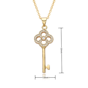 Detail shot of heart key pendant in 18k gold finish with white zircon crystals