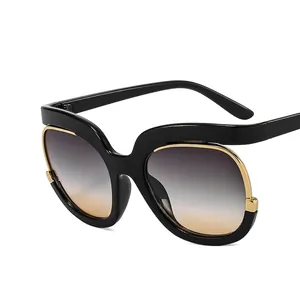 Chic black cat-eye sunglasses for women with gold trim and gradient lenses