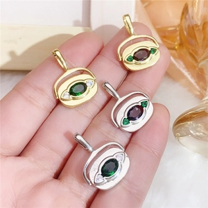 Detail of copper gold and silver pendants with green, purple and white zircons