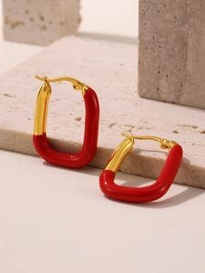 Close-up of geometric red enamel earrings with gold-plated stainless steel finish
