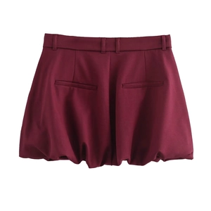 Detailed flat lay of dark red bubble shorts featuring back loops and faux pocket design