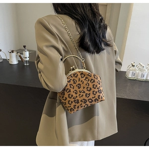 Leopard print velvet shell bag with gold chain strap worn by a model in beige blazer