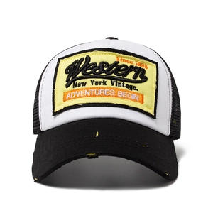 Vintage trucker hat with distressed black brim and yellow Western embroidery patch