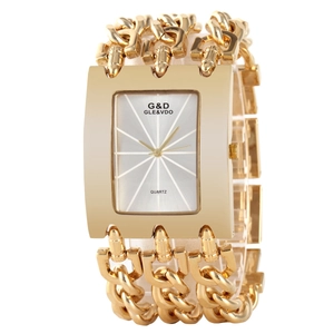Detailed close-up of a gold square dial quartz watch with wide metal chain link strap