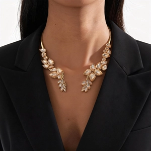 Detailed view of luxury gold leaf necklace with champagne crystal drops on model