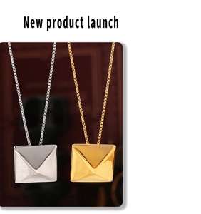 Detail of 18k gold and silver geometric envelope pendants on fine box chains