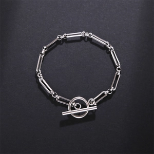 Detail of silver paperclip chain bracelet featuring a classic T-Bar OT toggle closure