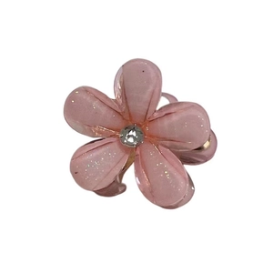 Pink camellia flower mini hair claw clip with glitter finish and sparkling rhinestone center