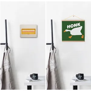 Minimalist wooden scroll wall art featuring a cartoon white goose with HONK lettering