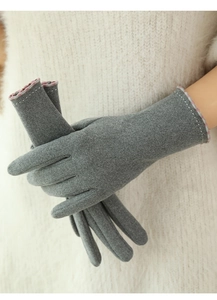 Close-up of grey thermal gloves with pink and white patterned cuffs for winter use