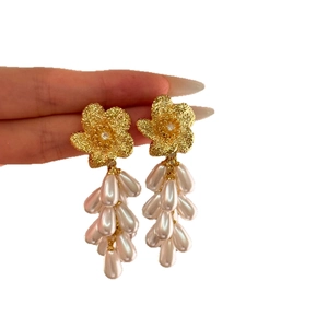 Elegant gold flower earrings with sparkling zircons and white teardrop pearl drops