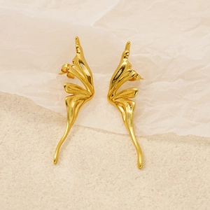 Detailed view of golden butterfly wing earrings with polished fluid organic curves