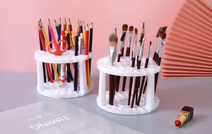 Close-up of a white multi-hole circular organizer for makeup brushes and stationery on desk