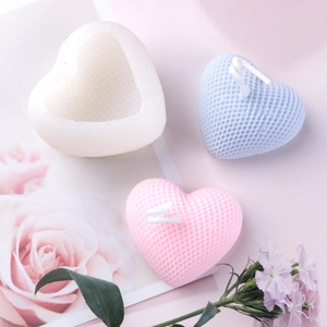 Macro detail showing heart-shaped silicone mold and textured scented candles for DIY craft