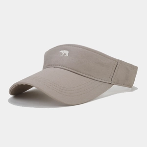 Close-up detail of a khaki outdoor sun visor hat featuring a small white polar bear embroidery