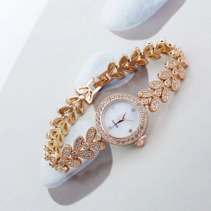 Elegant gold quartz bracelet watch for women featuring sparkling rhinestone heart links