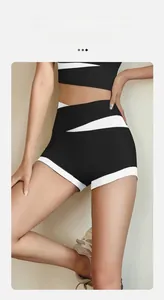 Detail showing high-waisted fitness shorts with black and white contrast stitching design