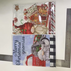 Two Christmas garden flags with cartoon gnomes and gingerbread man patterns in linen fabric