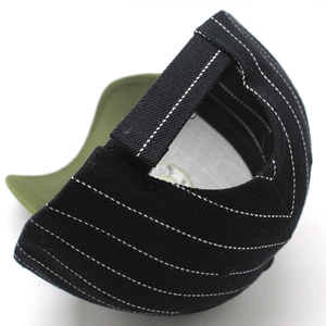 Black cotton baseball cap with white contrast stitching and green underbrim detail