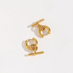 Detail of gold-tone T-bar drop earrings with polished minimalist hoop design
