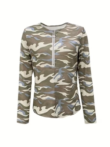 Close-up of camouflage waffle knit fabric with a metal half-zipper and ring puller