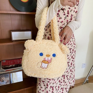Close-up of cozy lamb wool handbag featuring cute cartoon embroidery in a warm home setting