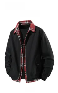 Detail of red plaid collar lining and zipper closure on a black casual jacket