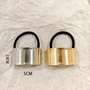 Detail view of 2.8x5cm gold and silver hollow metal hair ties with black elastic rope
