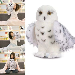 Detail view of a white snowy owl plush toy featuring realistic spotted feather patterns