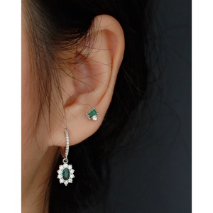 S925 silver flower earrings with emerald green stones and zircon worn on a model side view