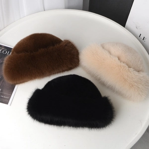Detailed texture of fluffy faux fur winter hats in brown, beige, and black colors
