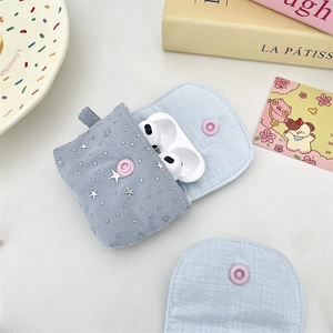 Close-up of light blue checkered earphone pouch with silver star studs and pink snap button
