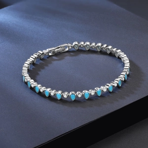 Macro view of S925 sterling silver tennis chain featuring blue teardrop stones and zircon