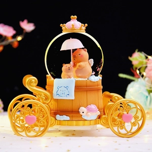 Golden carriage crystal ball music box with capybara figures and glowing snow features