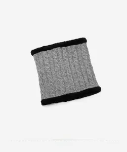 Detail of grey cable-knit winter neck gaiter with thick black faux fur lining