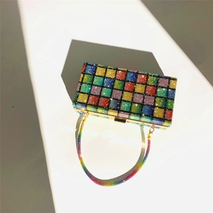 Macro shot of rainbow rhinestone clutch bag with checkered pattern and gold chain strap