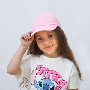 Detailed view of kids pink baseball cap paired with a Stitch graphic cartoon t-shirt
