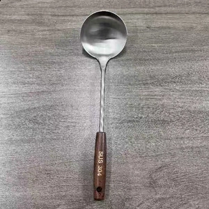 Macro detail of stainless steel soup ladle with ergonomic wooden handle and SUS 304 stamp