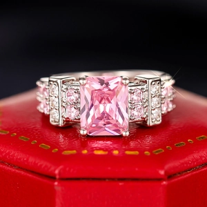 Macro shot of a rectangular pink zircon ring with four-prong setting on a red box