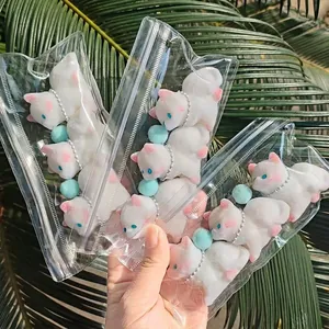 Three-pack white cat squishy toys with mint pompom in a clear zipper bag set