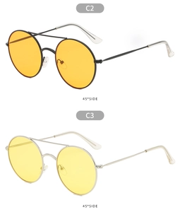 Detail of vintage metal double-bridge sunglasses with orange and yellow tinted lenses