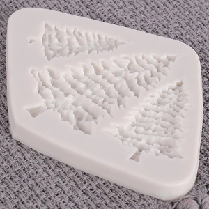 Detailed view of flexible white silicone mold with two Christmas tree shaped cavities