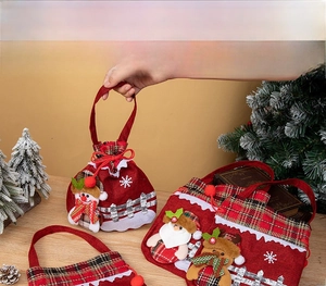Detailed view of red Christmas gift bags with 3D snowman, Santa, and reindeer designs
